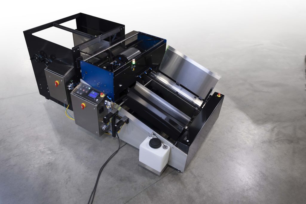 Industrial printer with control panel and sheet feeder on concrete floor